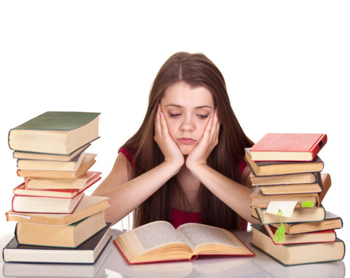 Young girl studying with book isolated